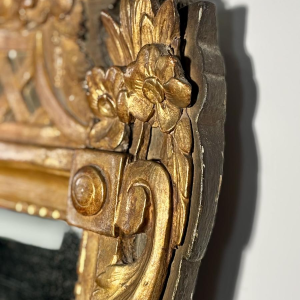 Mirror with a wooden and gilded stucco pediment - Louis XVI period - 18th century