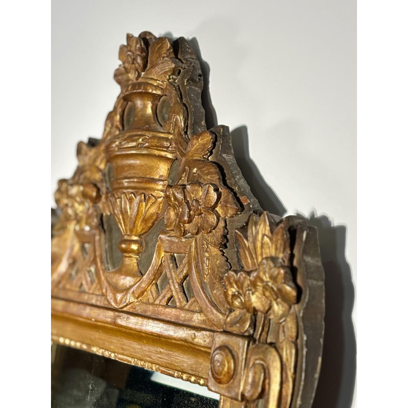 Mirror with a wooden and gilded stucco pediment - Louis XVI period - 18th century