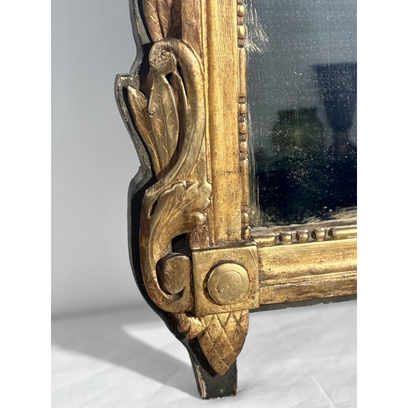 Mirror with a wooden and gilded stucco pediment - Louis XVI period - 18th century