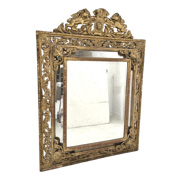 Louis XIV style closed-panel mirror in wood and gilt stucco, pediment with escutcheon and lions, 19th century