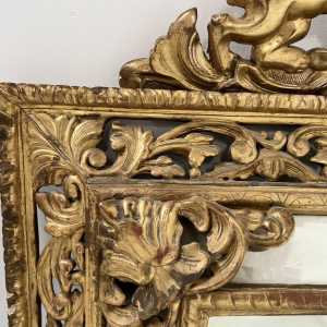 Louis XIV style closed-panel mirror in wood and gilt stucco, pediment with escutcheon and lions, 19th century