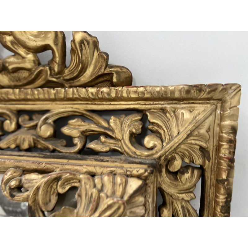 Louis XIV style closed-panel mirror in wood and gilt stucco, pediment with escutcheon and lions, 19th century
