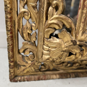Louis XIV style closed-panel mirror in wood and gilt stucco, pediment with escutcheon and lions, 19th century