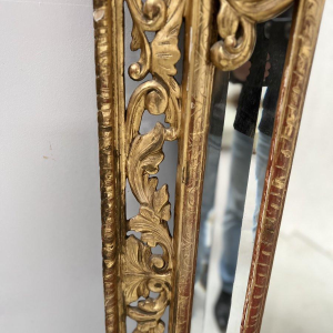 Louis XIV style closed-panel mirror in wood and gilt stucco, pediment with escutcheon and lions, 19th century