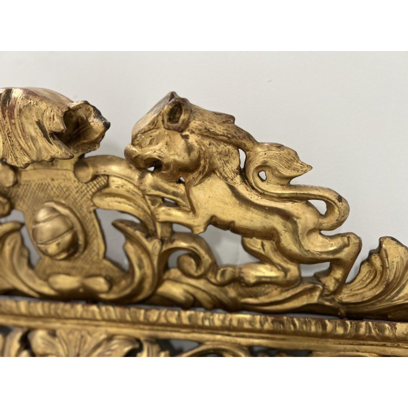Louis XIV style closed-panel mirror in wood and gilt stucco, pediment with escutcheon and lions, 19th century