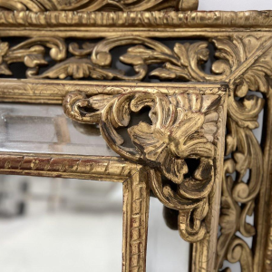 Louis XIV style closed-panel mirror in wood and gilt stucco, pediment with escutcheon and lions, 19th century