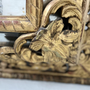 Louis XIV style closed-panel mirror in wood and gilt stucco, pediment with escutcheon and lions, 19th century
