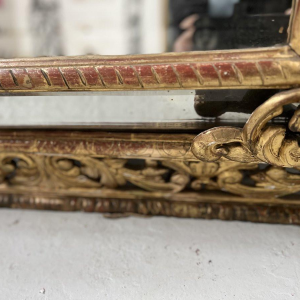 Louis XIV style closed-panel mirror in wood and gilt stucco, pediment with escutcheon and lions, 19th century