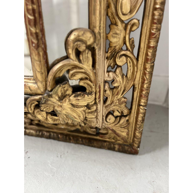 Louis XIV style closed-panel mirror in wood and gilt stucco, pediment with escutcheon and lions, 19th century