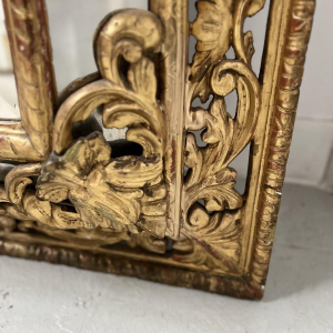 Louis XIV style closed-panel mirror in wood and gilt stucco, pediment with escutcheon and lions, 19th century