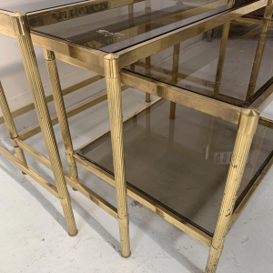 Set of three vintage nesting tables in brass and smoked glass, 20th century