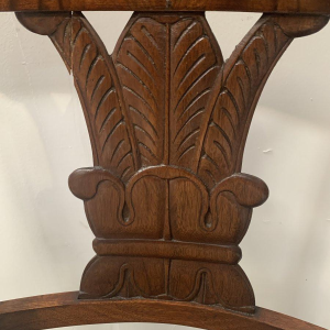Pair of mahogany armchairs with curved backs decorated with palmettes, 19th century