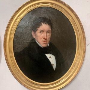 Pair of ancestral portraits, oil on canvas in gilt oval frames, 19th century