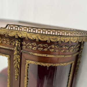 A curved display cabinet in the Napoleon III style, made of mahogany and veneer, 20th century