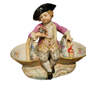 Meissen porcelain 'Child with baskets' polychrome salt shaker statuette, 19th century