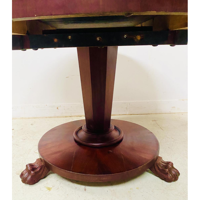 Round Empire mahogany side table with a central four-legged "lion's paw" base, 19th century