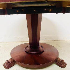Round Empire mahogany side table with a central four-legged "lion's paw" base, 19th century