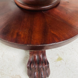 Round Empire mahogany side table with a central four-legged "lion's paw" base, 19th century