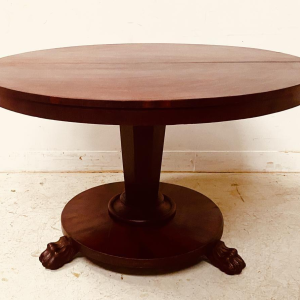 Round Empire mahogany side table with a central four-legged "lion's paw" base, 19th century