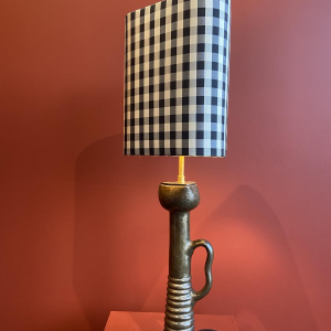 Bronze table lamp with a black and white checkered silk lampshade
