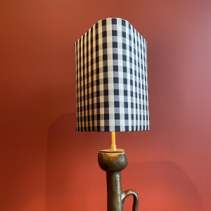 Bronze table lamp with a black and white checkered silk lampshade