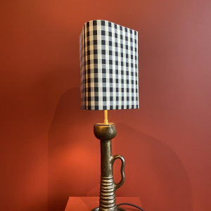 Bronze table lamp with a black and white checkered silk lampshade