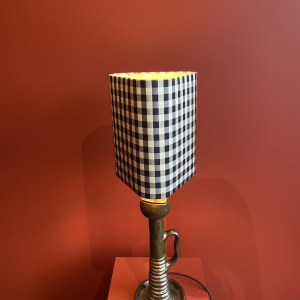 Bronze table lamp with a black and white checkered silk lampshade