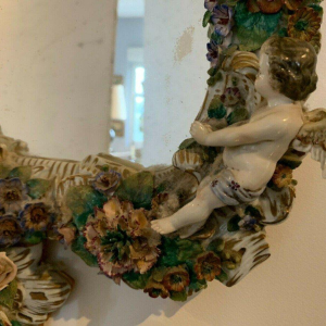 Pair of mirrors with candlesticks, decorated with cherubs, German polychrome porcelain, early 20th century