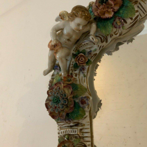 Pair of mirrors with candlesticks, decorated with cherubs, German polychrome porcelain, early 20th century