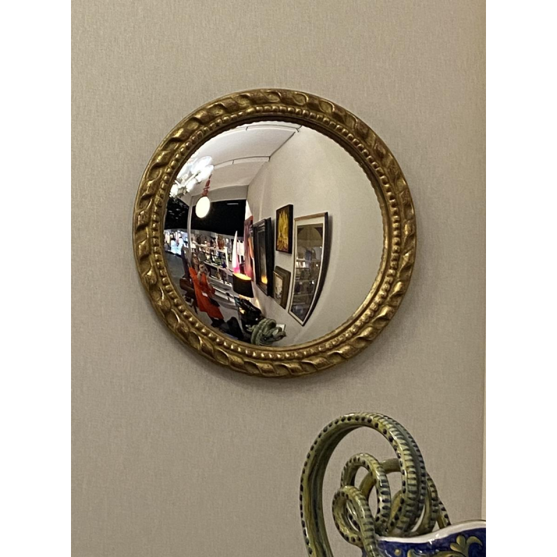 Circular "witch's eye" mirror in gilded carved wood