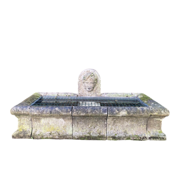 Large, old outdoor stone basin forming a fountain, circa 1900