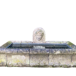Large, old outdoor stone basin forming a fountain, circa 1900
