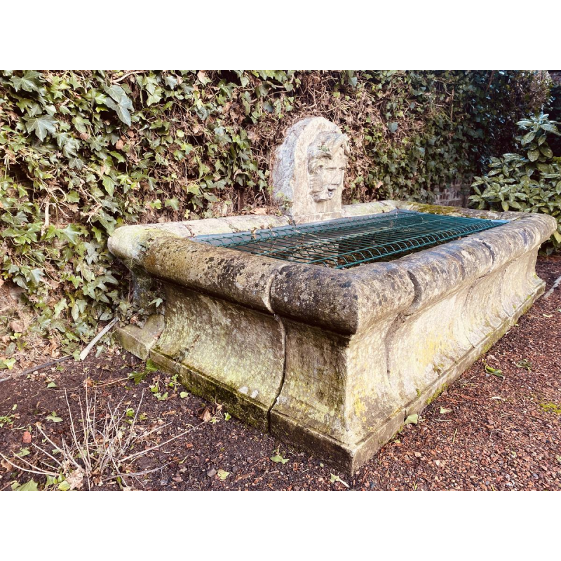 Large, old outdoor stone basin forming a fountain, circa 1900