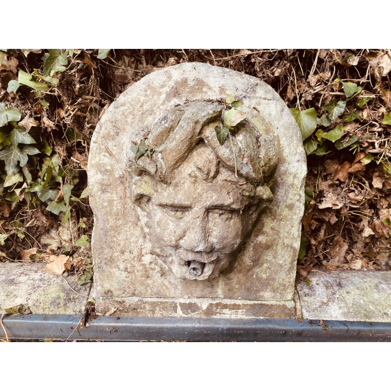 Large, old outdoor stone basin forming a fountain, circa 1900