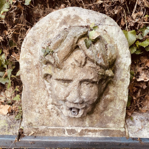 Large, old outdoor stone basin forming a fountain, circa 1900