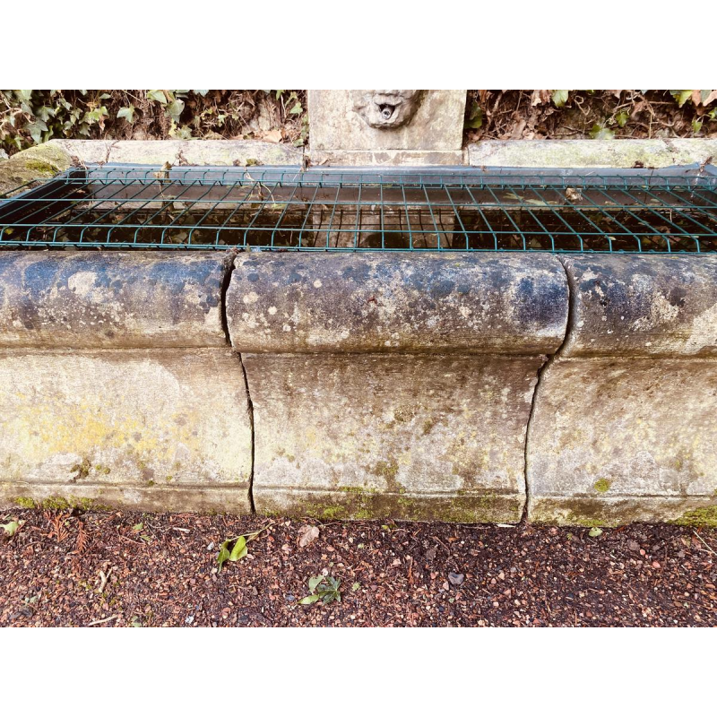 Large, old outdoor stone basin forming a fountain, circa 1900