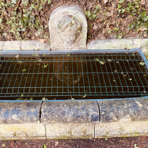 Large, old outdoor stone basin forming a fountain, circa 1900