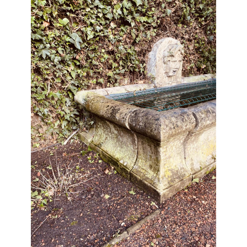 Large, old outdoor stone basin forming a fountain, circa 1900