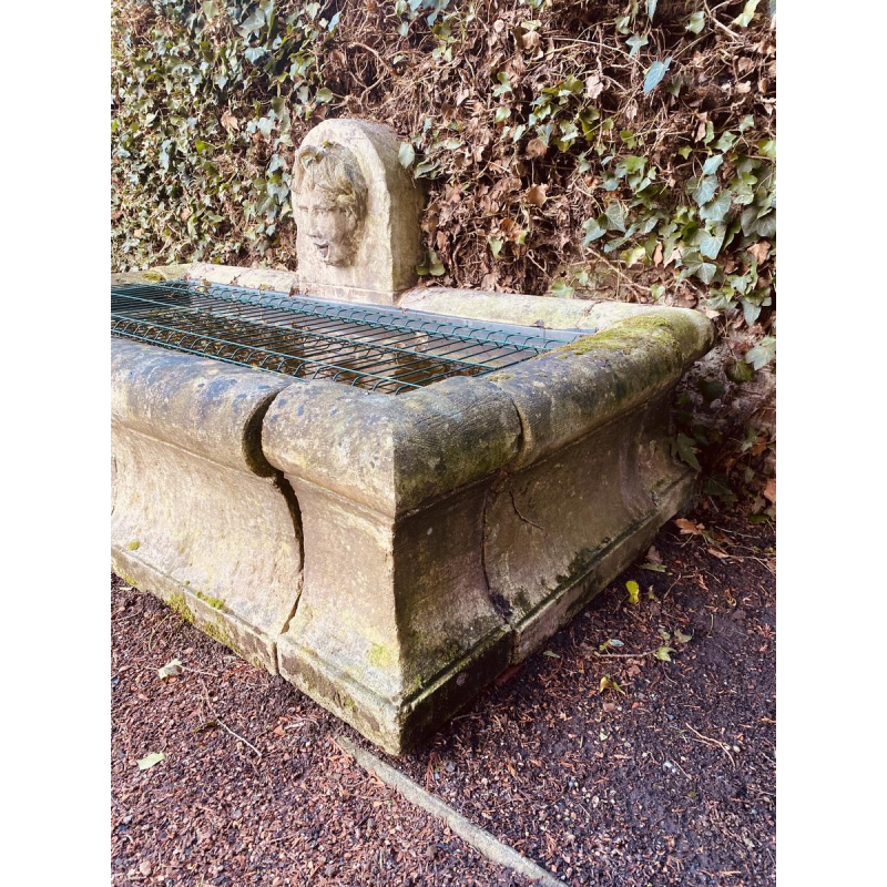 Large, old outdoor stone basin forming a fountain, circa 1900