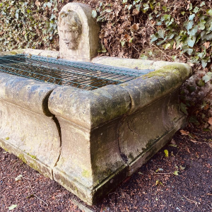 Large, old outdoor stone basin forming a fountain, circa 1900