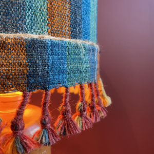 "Stoneware Bottle" lamp with a blue and multicoloured lampshade, handwoven in India