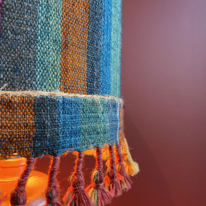 "Stoneware Bottle" lamp with a blue and multicoloured lampshade, handwoven in India