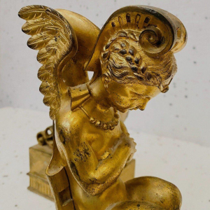 Paire de chenets en bronze doré à décor de faunes ailés, XIXᵉ siècle